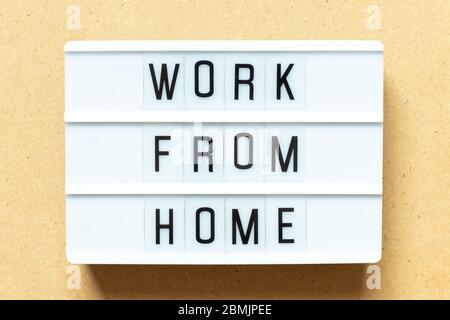 Lightbox with word work from home on wood background Stock Photo