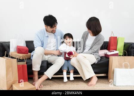 Young Asian mom and dad are unpacking gifts with their daughter Stock Photo  - Alamy