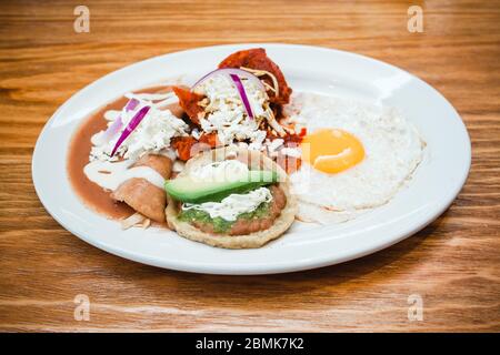 Mexican breakfast, eggs huevos, chilaquiles, sopes and enfrijoladas in Mexico Stock Photo