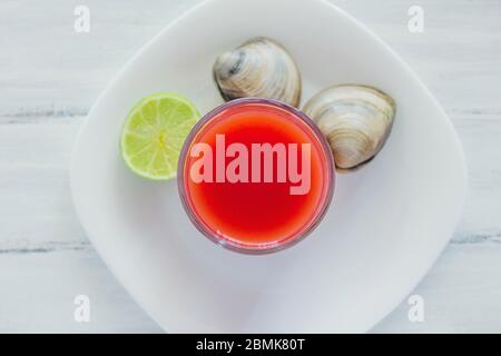 caldo de almeja, consome de almejas, clam cocktail with lemon and salted cookies mexican sea food in mexico Stock Photo