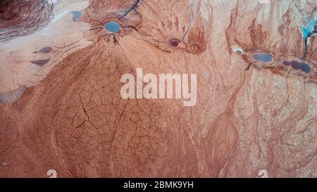 Abstract Aerial View of Red Tailing Ponds with Various Textures Stock Photo