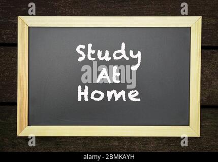 Study at home, words on blackboard. Notice or announcement. Stock Photo