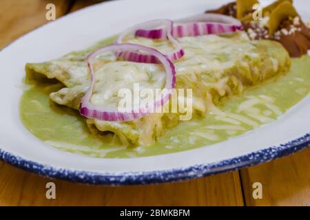 enchiladas verdes Mexican Food with onions and cheese in Mexico Stock Photo