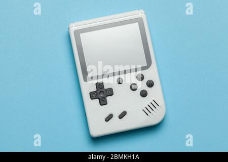 Old game console. Gamepad is white on blue background. Copy space for text. Stock Photo
