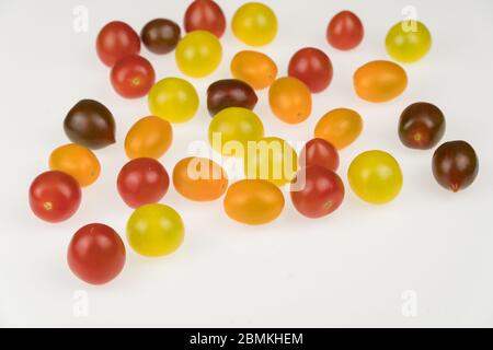 fresh multi-colored cherry tomatoes on a white background Stock Photo