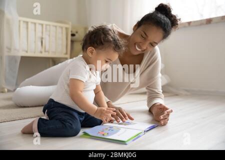Happy african American mom play with little baby Stock Photo