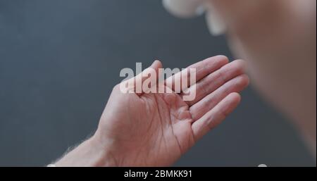 pov shot of man apply sanitizer gel to his hands closeup Stock Photo