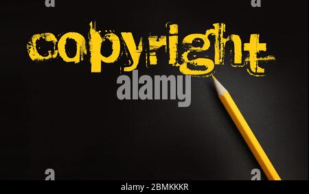 Copyright word in yelow on black and pencil besides. Trademark Identity Owner Legal Concept Stock Photo
