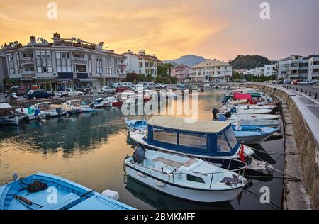 Marmaris marina landscape beautiful sunset citycape touristic destination view of Mugla city, Turkey. City lights landscape with boats in marina bay, Stock Photo