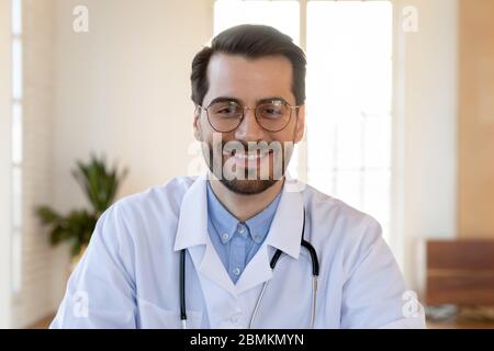 Portrait of smiling male doctor posing at workplace Stock Photo