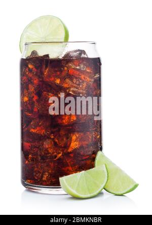 Cuba Libre Cocktail in tin shape glass with ice cubes and slices of lime on white background with raw limes Stock Photo