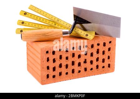 tools and brick as symbol for house construction Stock Photo