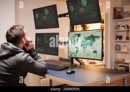 Angry hacker covering his face because couldn't hack government main server. Access denied. Stock Photo