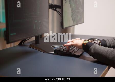 Close up of hacker hands writing a dangerous virus for cyberterrorism. Stock Photo