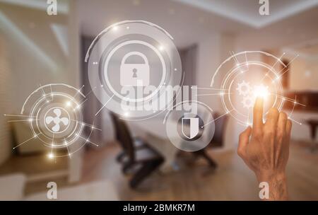 Young guy using smart home digital interface, collage with pictograms on imaginary screen Stock Photo