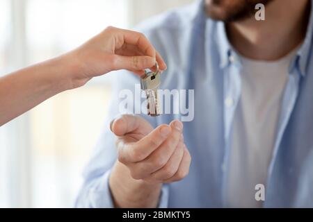 Close up of relator give keys to male client Stock Photo