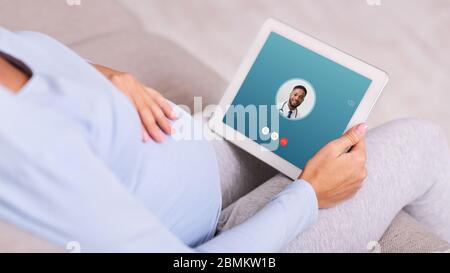 Woman having video chat with male doctor using tablet Stock Photo