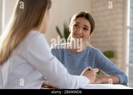 Female doctor consulting patient at hospital meeting Stock Photo