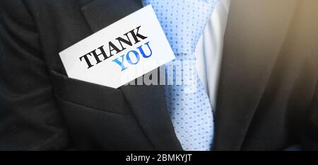 Thank you words on a card in businessman's pocket. Business concept Stock Photo
