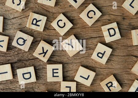 background of letterpress wood type printing blocks on wooden background, random letters of alphabet and punctuation stained by black inks Stock Photo