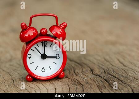 Red alarm clock on wood background with copy space Stock Photo