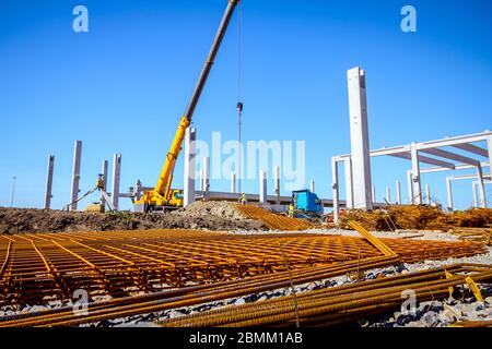 View on rusty square reinforcement for concrete, construction site is in background. Stock Photo