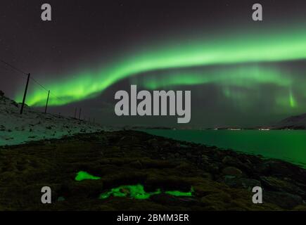 Green lights glowing in the land and sky Stock Photo