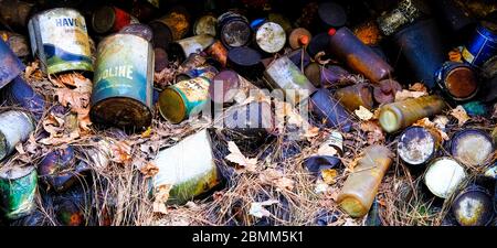 Old Oil Cans in Woods Stock Photo