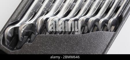 Spanners. Many wrenches inside boxtool. Grey background. Set of wrenches in different sizes on grey background. Stock Photo