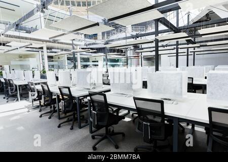 Big empty rental office for IT workers with wrapped in cover computers Stock Photo