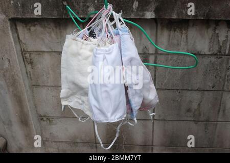 The face mask made of many fabrics is dry to the sun. After being used and washed for cleaning. Stock Photo