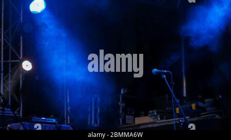 Free stage with blue lights before concert, lighting devices, microphone Stock Photo