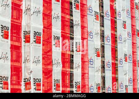 Baumit branded banners building scaffolding wrapped as advertisement on a construction site Stock Photo