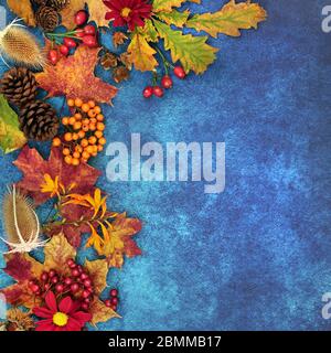 Autumn background border with food, flora and fauna on mottled blue background. Harvest festival theme top view. Stock Photo