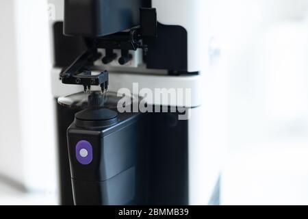 Glasses Manufacturing Process. Optician polishing glasses in optical shop Stock Photo