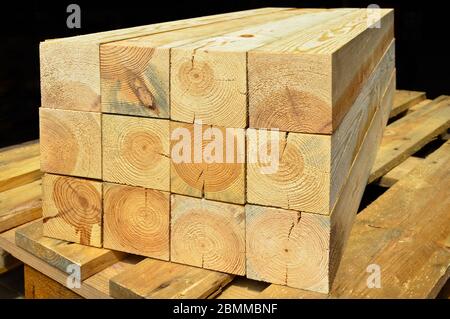 Pine lumber stacked in a row at the sawmill, lumber stack for storage construction or industrial work, sawn pine timber Stock Photo