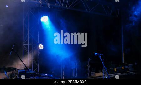 Free stage with blue lights before concert, lighting devices, microphone Stock Photo