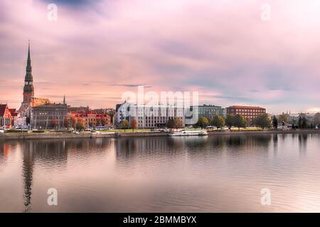 Skyline of Riga and the river Daugava in the morning,  Latvia.  St. Peter's Church (left). Delicate pink morning Stock Photo