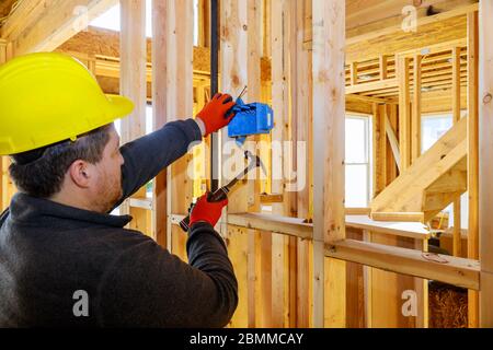 Worker puts on electrical outlets installation in new home Stock Photo