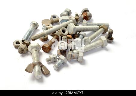 Pile of loose nuts & bolts on white. Stock Photo