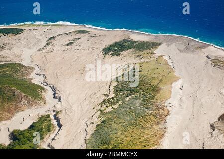 The remains of recent pyroclastic flows of the Soufriere Hills Volcano at the  east coast of Montserrat. Aerial view from helicopter. Stock Photo