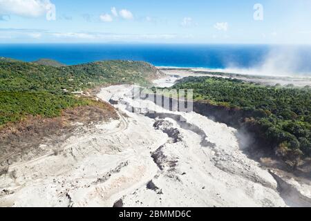 The remains of recent pyroclastic flows of the Soufriere Hills Volcano at the  east coast of Montserrat. Aerial view from helicopter. Stock Photo