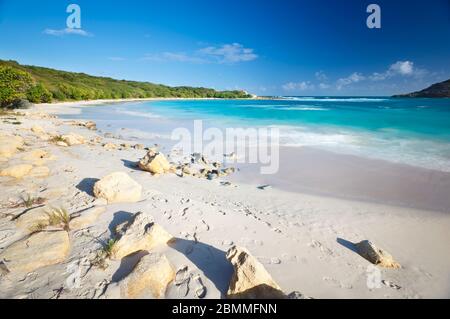 Daytime long exposure of the beautiful Half Moon Bay in Antigua. Stock Photo