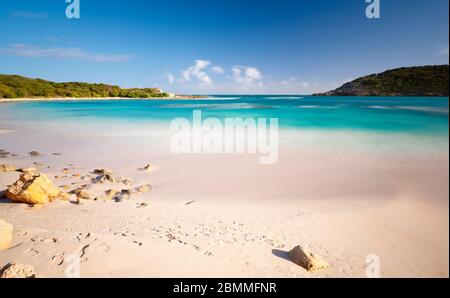 Daytime long exposure of the beautiful Half Moon Bay in Antigua. Stock Photo