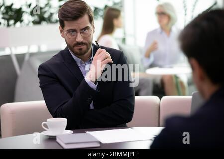 Headhunter looking at applicant with distrust failed job interview concept Stock Photo