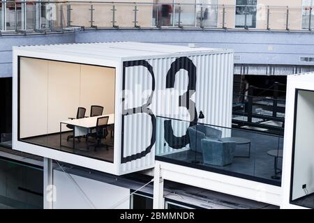 Workplaces and rest zone for workers on second floor in big open space office Stock Photo