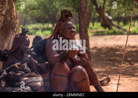 Kamanjab, Namibia - March 14, 2017: Himba women with traditional hairstyle in Otjikandero Himba Orphanage Village Stock Photo