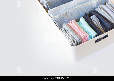 Box with brught socks, closeup. sort up socks. White background. Basket.