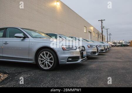 CHICAGO, ILLINOIS, UNITED STATES - DEC 11th, 2015: A lot of cars in a row. Car rental service with silver sedan cars Stock Photo