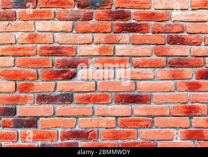 Old weathered red brick wall as background. Bricks masonry with seams Stock Photo